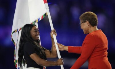 Simone Biles carrying the flag