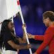 Simone Biles carrying the flag