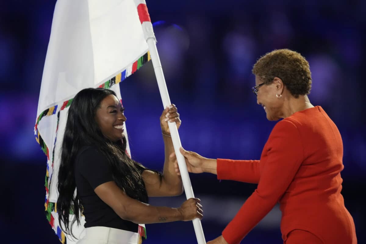 Simone Biles carrying the flag